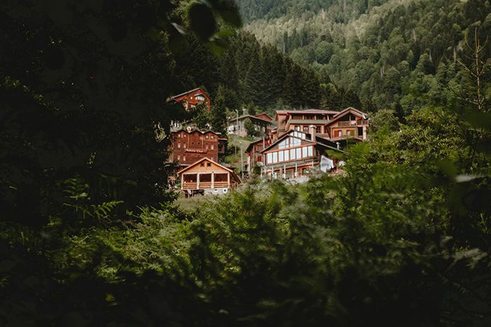 An image of brown houses on the top of hill