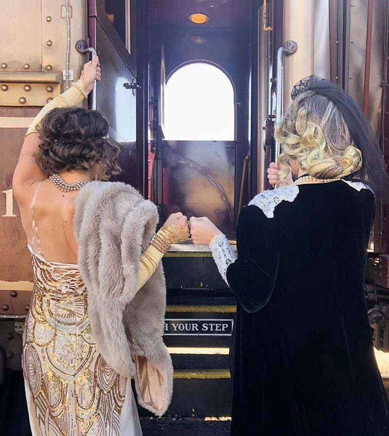 An image of two women boarding the muder mystery train