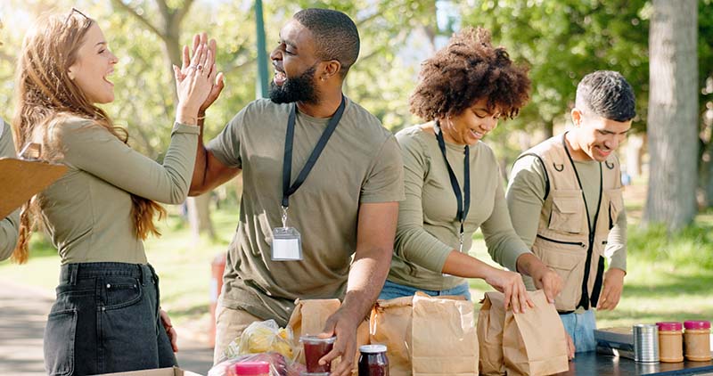 shutterstock_2469643817 A happy group of people doing community service